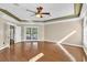 Spacious living room featuring hardwood floors, French doors, and a ceiling fan at 4404 Lake In The Woods Dr, Spring Hill, FL 34607