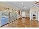 Spacious living room features hardwood floors, neutral walls, and sliding glass doors to the outdoor pool at 4404 Lake In The Woods Dr, Spring Hill, FL 34607