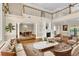 Open-concept living area featuring hardwood floors, a marble fireplace, and views into the dining room at 4404 Lake In The Woods Dr, Spring Hill, FL 34607