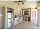 Stylish outdoor kitchen featuring stainless steel appliances, granite counters, and a built-in grill at 4404 Lake In The Woods Dr, Spring Hill, FL 34607