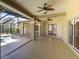 Expansive covered patio with ceiling fans and access to the screened pool area is perfect for entertaining at 4404 Lake In The Woods Dr, Spring Hill, FL 34607