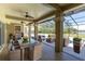 Outdoor patio with dining, lounge seating, outdoor grill, and pool access; perfect for gatherings at 4404 Lake In The Woods Dr, Spring Hill, FL 34607