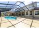 Spacious screened-in pool area, featuring a pool and spa for ultimate relaxation at 4404 Lake In The Woods Dr, Spring Hill, FL 34607
