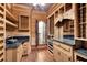 Elaborate wine cellar with custom wooden shelves, a sink and ornate doors at 4404 Lake In The Woods Dr, Spring Hill, FL 34607