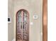 Ornate wrought iron door with glass paneling, perfect for a wine room or cellar at 4404 Lake In The Woods Dr, Spring Hill, FL 34607