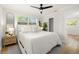 Comfortable bedroom with a queen bed, ceiling fan, natural light, and modern decor at 4517 S Hale Ave, Tampa, FL 33611