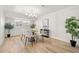 Bright dining room with a round table, four chairs, wood floors, and a large window at 4517 S Hale Ave, Tampa, FL 33611