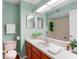 Bright bathroom featuring a large mirror, vanity, toilet, and tub/shower combination at 5704 Bratton Dr # 2, Tampa, FL 33617
