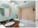 This bathroom features granite counters, a commode and a tub with tile surround at 5704 Bratton Dr # 2, Tampa, FL 33617