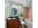 Well-lit bathroom with granite countertops, commode, and tub at 5704 Bratton Dr # 2, Tampa, FL 33617