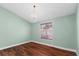 A well-lit room featuring new hardwood floors, a modern chandelier, and fresh green paint at 5704 Bratton Dr # 2, Tampa, FL 33617