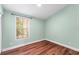 A clean bedroom featuring hardwood floors and a bright window at 5704 Bratton Dr # 2, Tampa, FL 33617