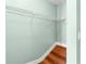 A wire rack offers storage in this closet with wood floors and mint colored walls at 5704 Bratton Dr # 2, Tampa, FL 33617