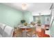 Bright dining area featuring a round table, four chairs, and hardwood floors at 5704 Bratton Dr # 2, Tampa, FL 33617