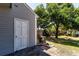 Exterior view of house with white door, green grass, and an AC unit at 5704 Bratton Dr # 2, Tampa, FL 33617