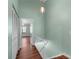 Hallway featuring wood floors and access to bedrooms at 5704 Bratton Dr # 2, Tampa, FL 33617