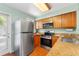 Well-equipped kitchen featuring stainless steel appliances and granite countertops at 5704 Bratton Dr # 2, Tampa, FL 33617