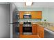 Kitchen with modern appliances, wood cabinets, and stone countertops at 5704 Bratton Dr # 2, Tampa, FL 33617