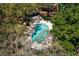 Aerial view of a kidney-shaped pool surrounded by trees and lounge chairs at 5704 Bratton Dr # 2, Tampa, FL 33617