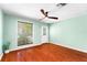 Sunlit room with hardwood floors, fan, window with blinds, and access to the outdoors at 5704 Bratton Dr # 2, Tampa, FL 33617