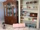 Dining room boasts built-in shelves and display cabinet; a cat adds character at 6406 Stone Rd, Port Richey, FL 34668