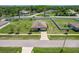Aerial view of a home with a spacious yard, driveway, and surrounding neighborhood at 733 Garden Oaks Sq, Seffner, FL 33584