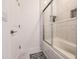 A full bath including decorative marble-like tile, a bathtub and clear shower door at 733 Garden Oaks Sq, Seffner, FL 33584