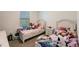 bedroom featuring two beds, a nightstand, and decor with a variety of stuffed animals at 733 Garden Oaks Sq, Seffner, FL 33584