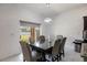 Modern dining room area with contemporary chandelier and views of the backyard at 733 Garden Oaks Sq, Seffner, FL 33584