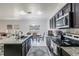 Modern kitchen with granite countertops, tiled backsplash, and stainless steel appliances at 733 Garden Oaks Sq, Seffner, FL 33584