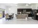Kitchen and dining room with dark cabinets, island and light tile flooring at 733 Garden Oaks Sq, Seffner, FL 33584