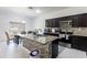 Open kitchen with granite countertops, tiled backsplash, and modern appliances at 733 Garden Oaks Sq, Seffner, FL 33584