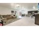 Open-concept living room and kitchen area with bright neutral tones and tile floors at 733 Garden Oaks Sq, Seffner, FL 33584