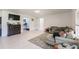 Spacious open-concept living room with bright neutral tones and modern white tile flooring at 733 Garden Oaks Sq, Seffner, FL 33584