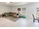 Bright living room and dining room area with bright neutral tones and tile floors at 733 Garden Oaks Sq, Seffner, FL 33584