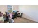 Bright office space featuring a built-in desk, ergonomic chairs, and a sunlit window at 733 Garden Oaks Sq, Seffner, FL 33584