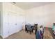 An office with a light carpet with two doors on the left and a study desk on the right at 733 Garden Oaks Sq, Seffner, FL 33584