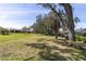 Expansive backyard with green grass, mature trees and manicured grounds at 7472 Clearmeadow Dr, Spring Hill, FL 34606