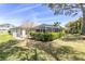 View of backyard, pool and patio area with manicured landscaping at 7472 Clearmeadow Dr, Spring Hill, FL 34606