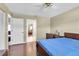 Hardwood floor bedroom includes ceiling fan and has entrance to bathroom at 7472 Clearmeadow Dr, Spring Hill, FL 34606