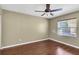 Bedroom featuring hardwood floors, neutral walls, and a bright window at 7472 Clearmeadow Dr, Spring Hill, FL 34606