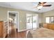 Bedroom featuring wood floors, ceiling fan, and access to the backyard at 7472 Clearmeadow Dr, Spring Hill, FL 34606