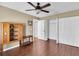 Hardwood floor bedroom includes ceiling fan, closet, and cabinet at 7472 Clearmeadow Dr, Spring Hill, FL 34606