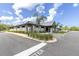 Attractive community center exterior with stone accents, well-kept landscaping, and ample parking at 7472 Clearmeadow Dr, Spring Hill, FL 34606