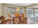 Dining area with wood table, chairs, and view of the pool at 7472 Clearmeadow Dr, Spring Hill, FL 34606