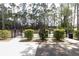 Fenced dog park with designated areas and walking paths, surrounded by lush trees and greenery at 7472 Clearmeadow Dr, Spring Hill, FL 34606