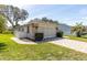 Well-kept single-story home featuring an attached garage and brick accents, surrounded by mature landscaping at 7472 Clearmeadow Dr, Spring Hill, FL 34606