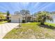 Charming home with brick driveway, mature landscaping, and a two-car garage at 7472 Clearmeadow Dr, Spring Hill, FL 34606