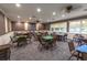 Game room with multiple tables and chairs, carpet, and decorative wall trim at 7472 Clearmeadow Dr, Spring Hill, FL 34606