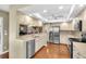 Well-lit kitchen featuring granite countertops, stainless steel appliances, and ample cabinet space at 7472 Clearmeadow Dr, Spring Hill, FL 34606
